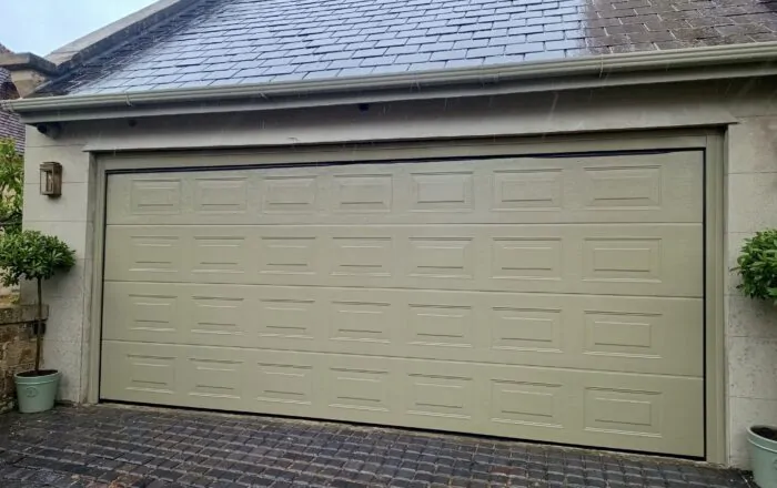 Double roller garage door in a neutral colour.